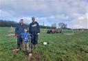 Jesse Davies and Tom and Mat Feakins plant the orchard.