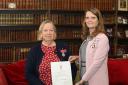 The Lord-Lieutenant of Powys Tia Jones (right) is pictured making the presentation to Christine Horton
