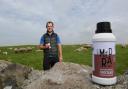 Dairy sheep farmer Huw Jones with the flavoured ewe's milk drinks and his flock at Ty'n Llan Farm ,Anglesey