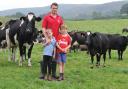 Rheinallt, pictured with Noah and Morgan, rotationally grazes the dairy herd Picture: Debbie James