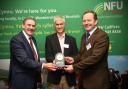 Sustainable Agriculture Award winner Aled Lewis (centre) with NFU Cymru president Aled Jones and Bryn Hughes of Wynnstay.