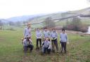 Volunteers planting trees at Glyn Canol Farm in Welshpool.