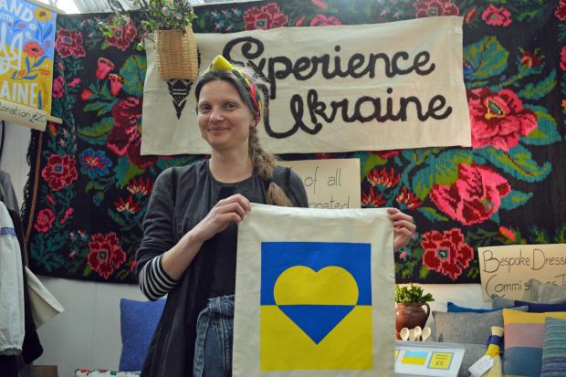 Nataliya Cummings from Experience Ukraine & Beyond with one of the bags bearing the flag of Ukraine.