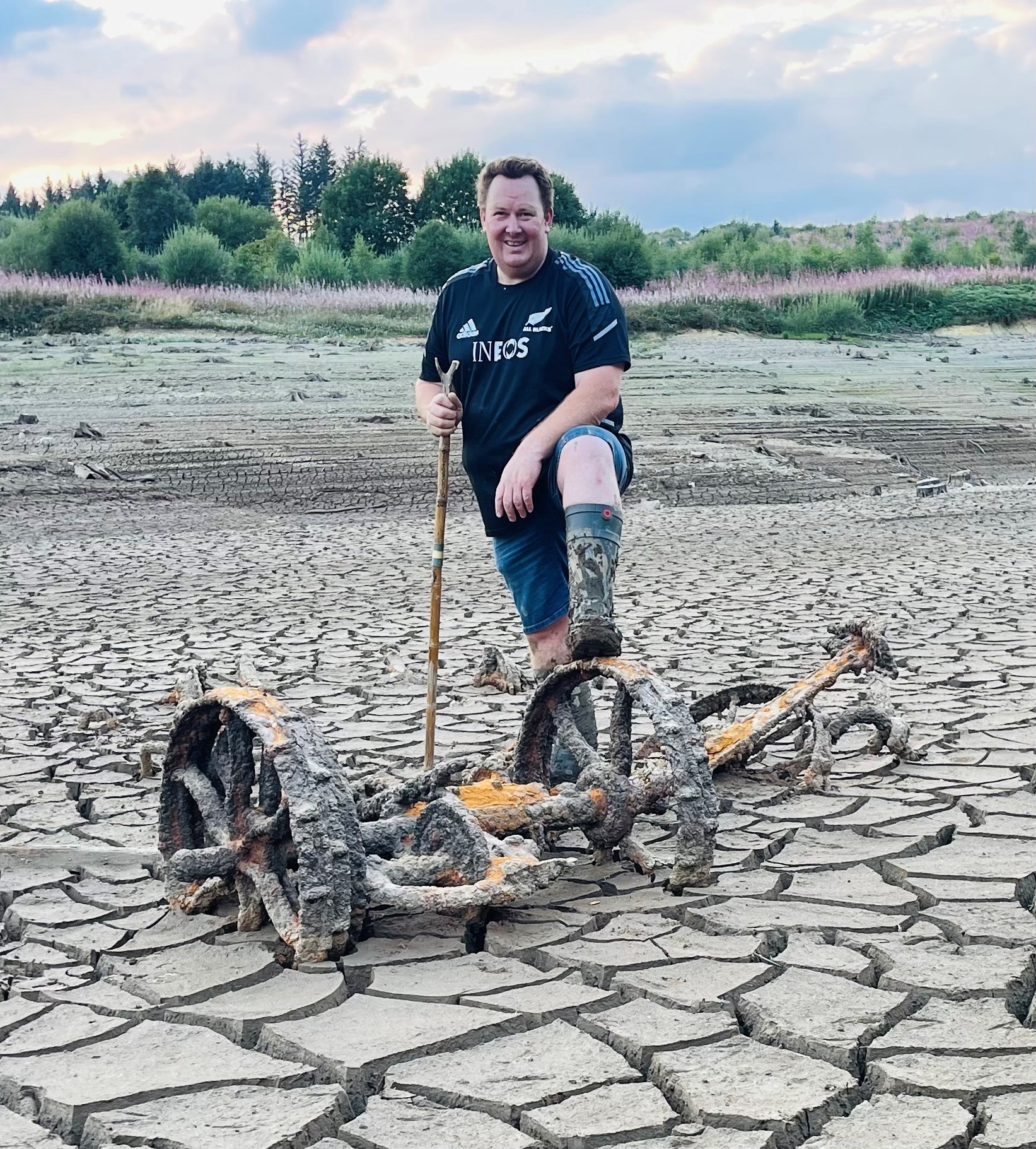 Aled Wyn Davies with an old horse-drawn mower that was left behind at Aberbiga Farm to make way for the Clywedog Reservoir. Picture by Aled Wyn Davies.
