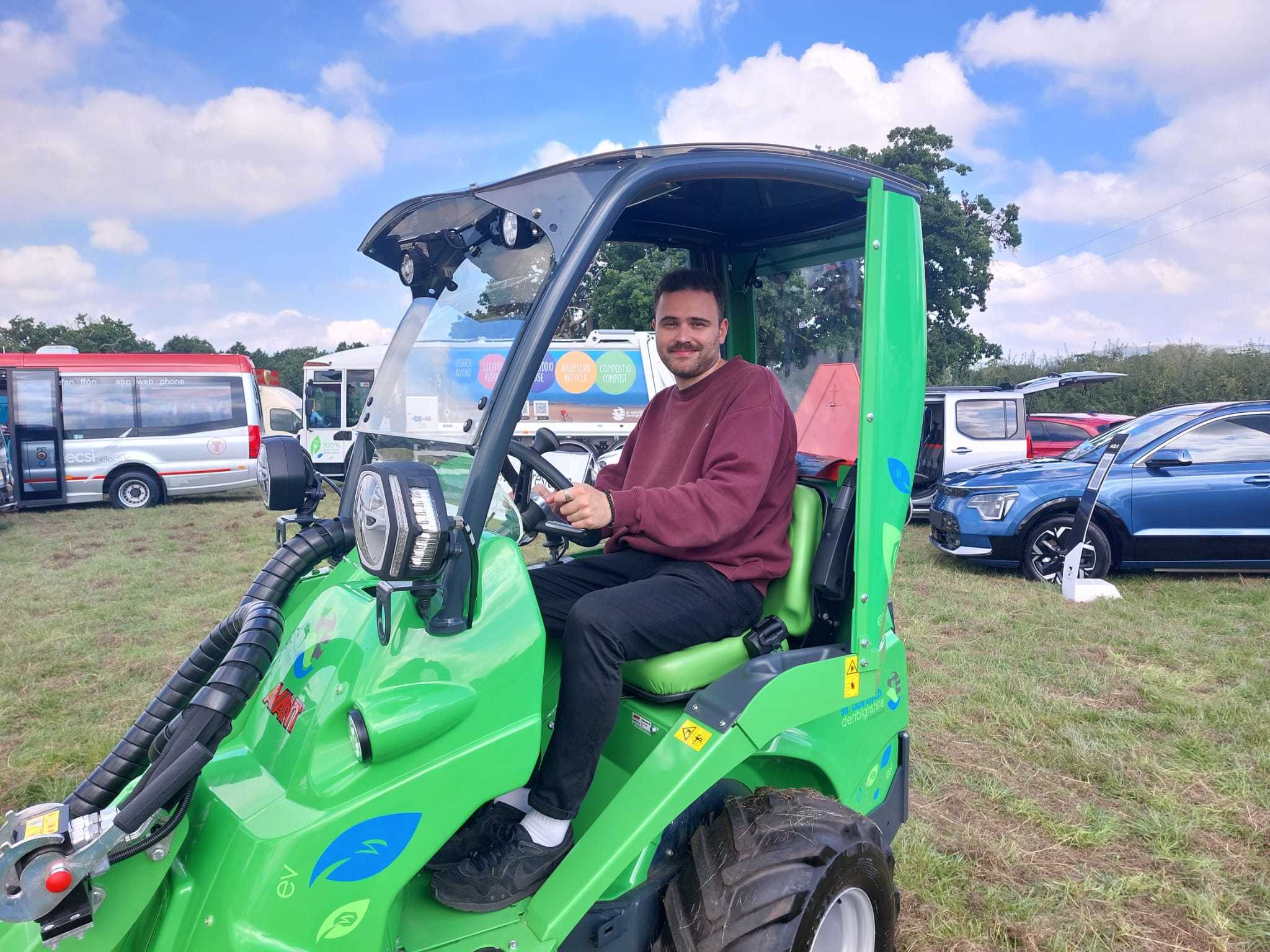 Reporter Mark Vranic test drives DCCs electric tractor.