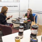 Lesley Griffiths, the Minister for Rural Affairs and North Wales, and Trefnydd with Carys Edwards of Gwenynfa Pen y Bryn Apiary in the Rising Stars area at BlasCymru/TasteWales 2021 
Picture: Nick Treharne