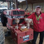 Mr Watkin with some of his many trophies for his competitive ploughing.