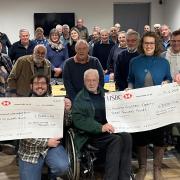 Mid Wales Vintage Machinery Club members presenting cheques to chosen charities.