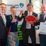 Llangurig Post Office and Stores win a Countryside Alliance Award in Cardiff Bay. From left: Russell George AM, Mary Davies, Gareth Wyn Jones, Colin Davies in 2019